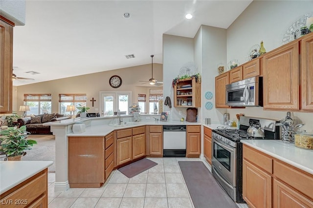 kitchen with appliances with stainless steel finishes, sink, ceiling fan, and kitchen peninsula