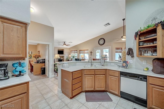 kitchen with dishwashing machine, sink, light tile patterned floors, ceiling fan, and kitchen peninsula