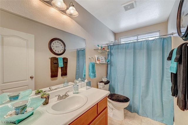 bathroom with walk in shower, tile patterned floors, toilet, and vanity