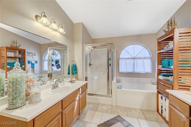 bathroom featuring tile patterned floors, a healthy amount of sunlight, and separate shower and tub