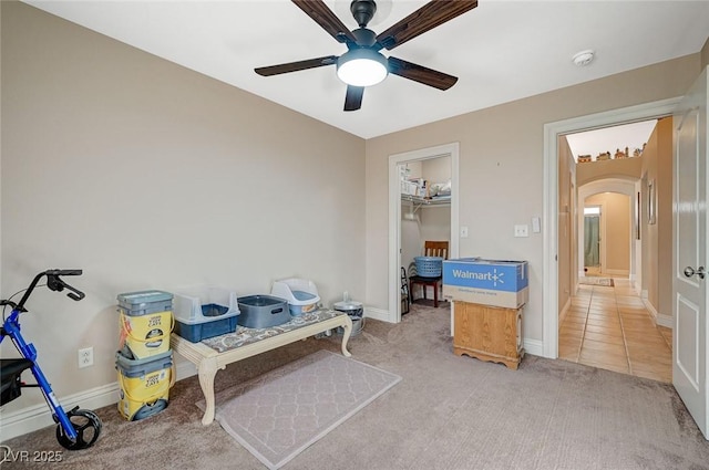 interior space with carpet and ceiling fan