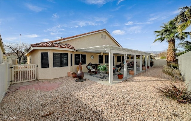 back of property featuring a patio and a pergola