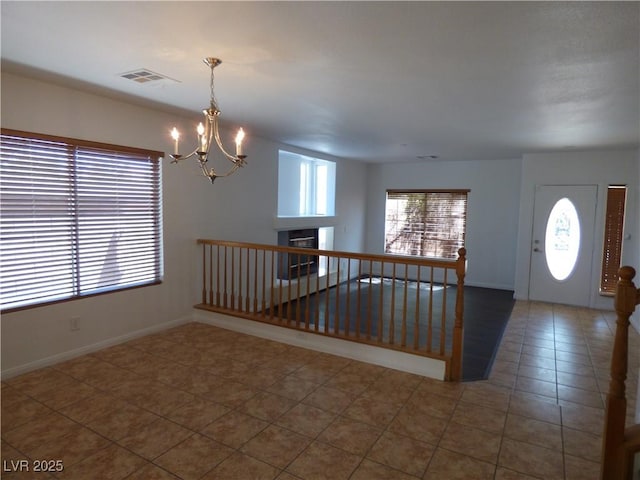 foyer entrance with a chandelier