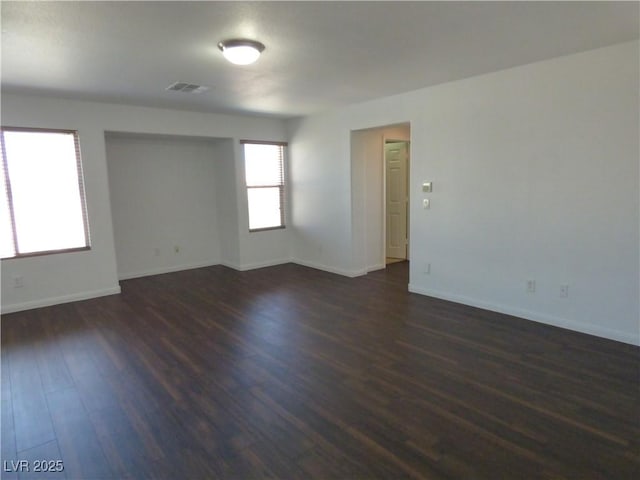 unfurnished room featuring dark hardwood / wood-style floors