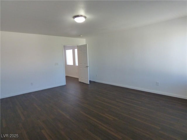 spare room with dark hardwood / wood-style flooring