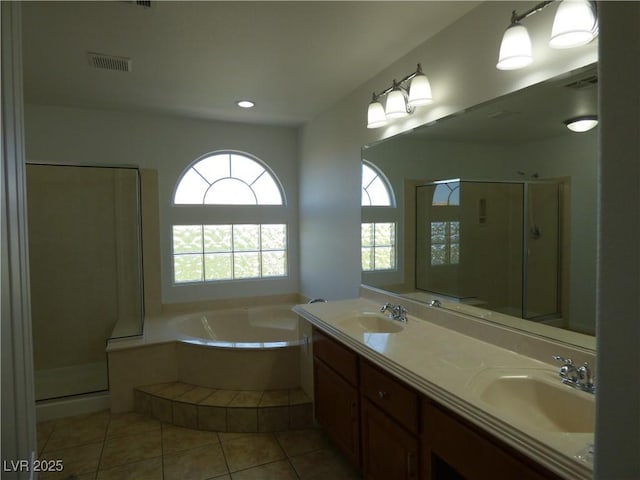 bathroom with tile patterned flooring, vanity, and shower with separate bathtub