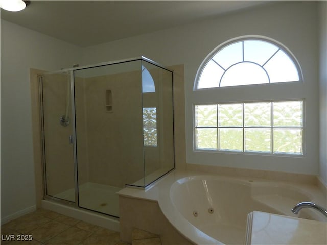 bathroom with independent shower and bath and tile patterned floors