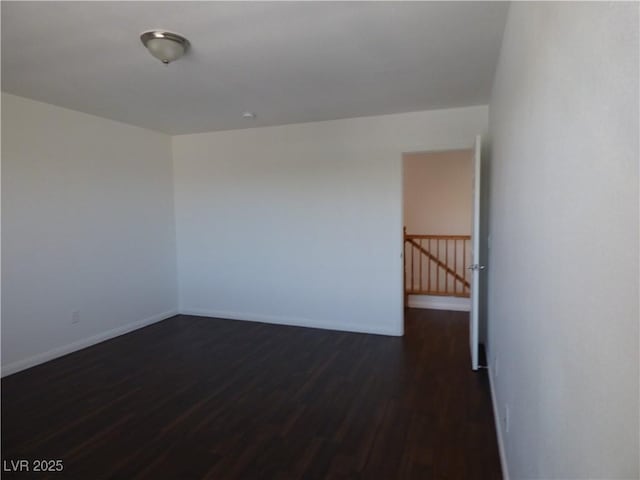 spare room featuring dark hardwood / wood-style flooring