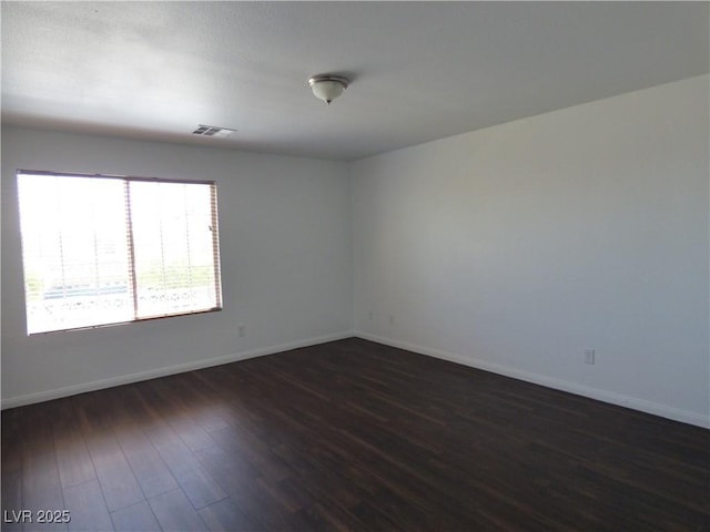 unfurnished room featuring dark hardwood / wood-style floors