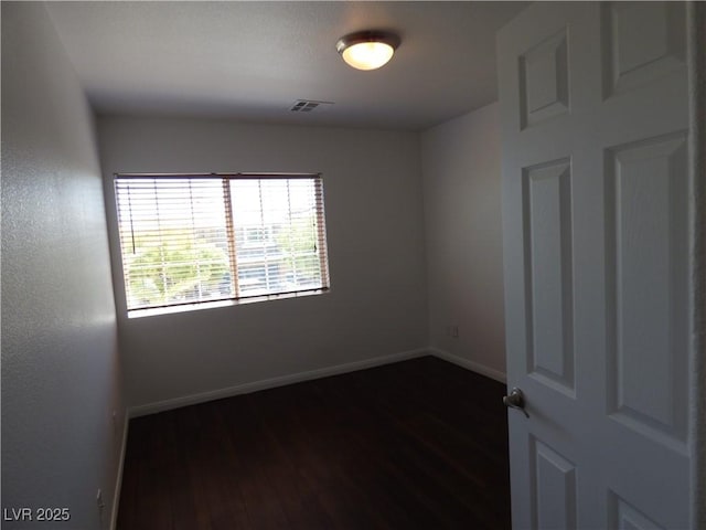 unfurnished room featuring dark hardwood / wood-style flooring