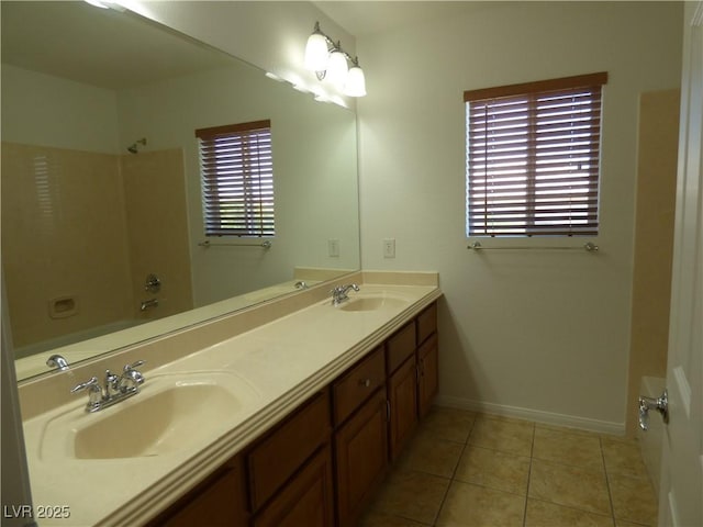 bathroom with vanity, shower / washtub combination, a wealth of natural light, and tile patterned floors