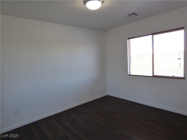 unfurnished room featuring dark wood-type flooring