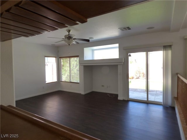 empty room featuring dark hardwood / wood-style flooring and ceiling fan