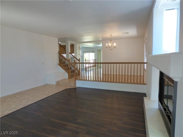 interior space with a notable chandelier and dark wood-type flooring