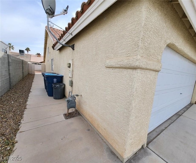 view of side of home featuring a garage