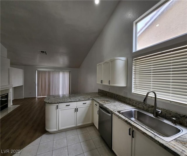 kitchen with sink, stainless steel dishwasher, white cabinets, and kitchen peninsula