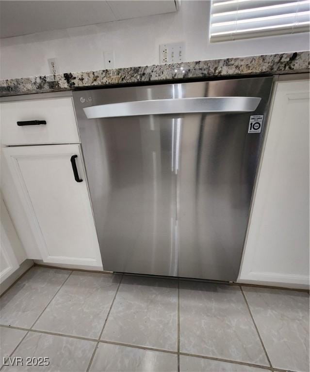 interior details with dishwasher and white cabinets