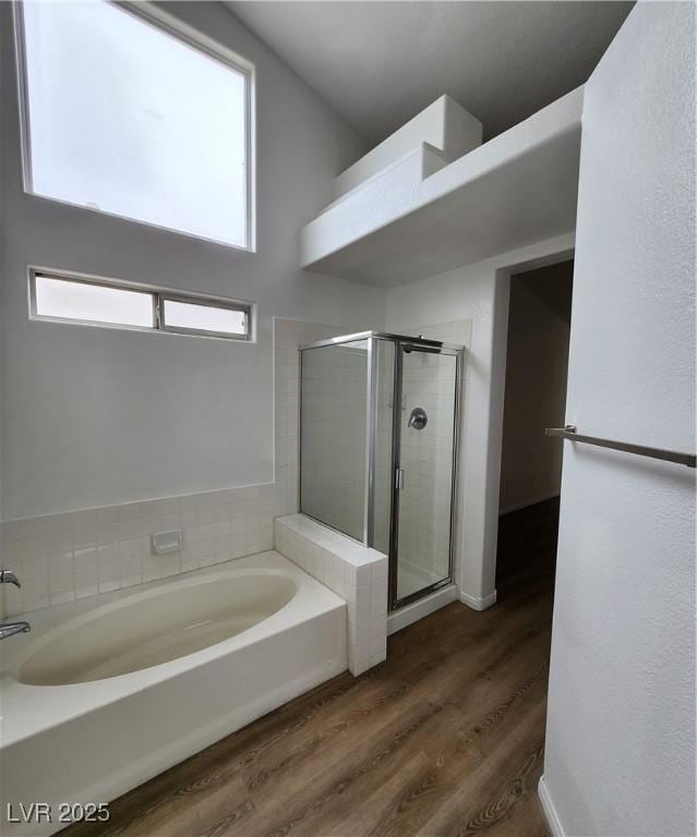 bathroom with plus walk in shower and hardwood / wood-style floors