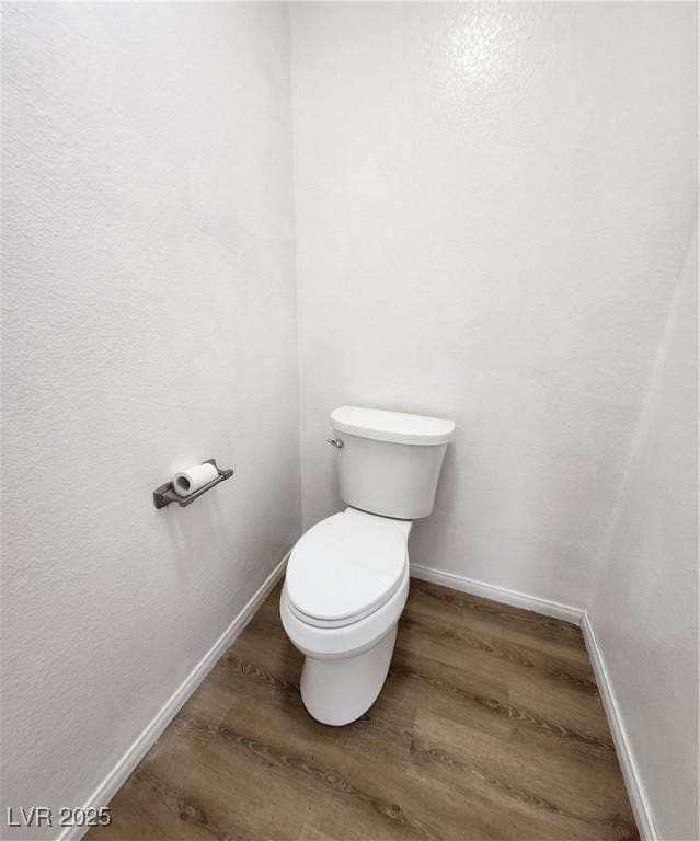 bathroom with hardwood / wood-style floors and toilet