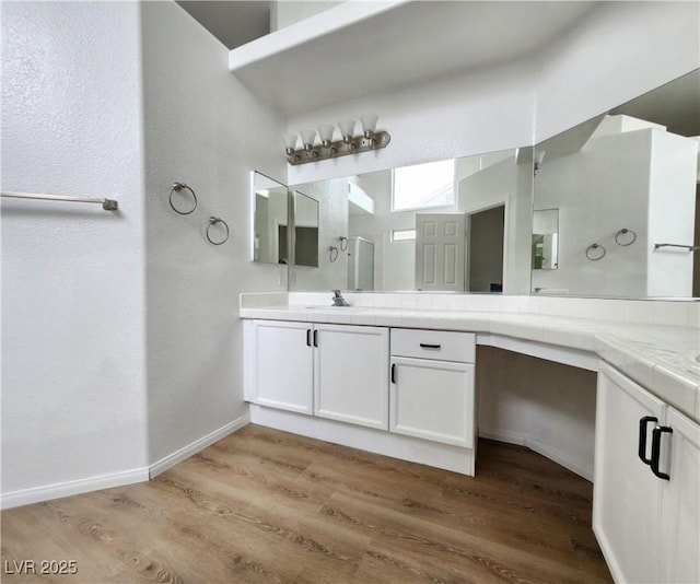 bathroom featuring hardwood / wood-style flooring and vanity