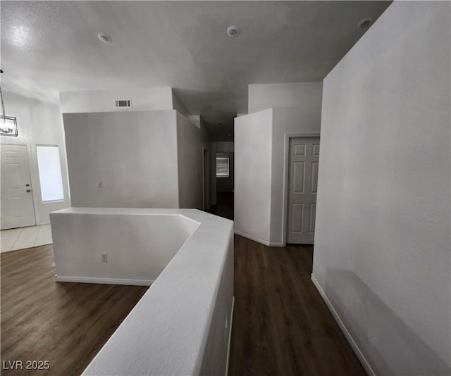 corridor featuring dark wood-type flooring