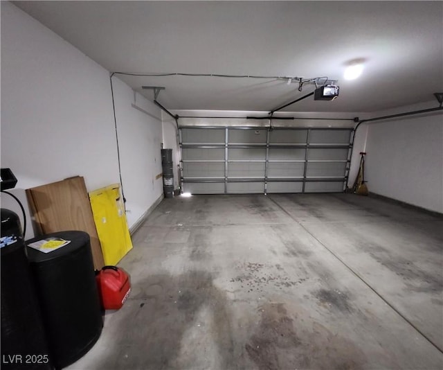 garage featuring a garage door opener and water heater