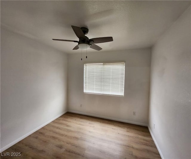 unfurnished room with light hardwood / wood-style flooring and ceiling fan