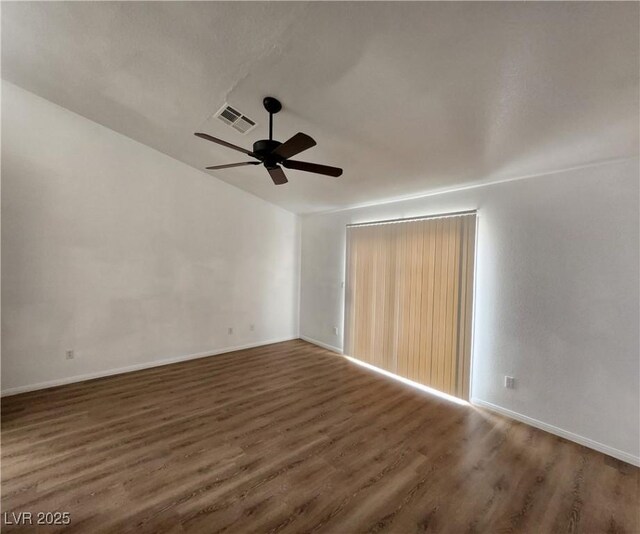 spare room with ceiling fan, dark hardwood / wood-style flooring, and vaulted ceiling