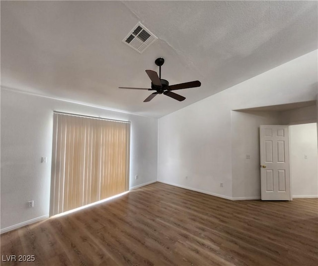 spare room featuring ceiling fan, lofted ceiling, and dark hardwood / wood-style floors