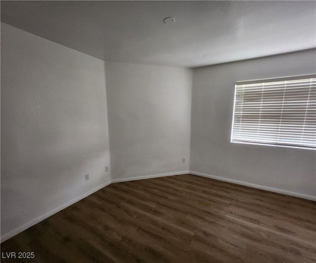 spare room with dark hardwood / wood-style flooring