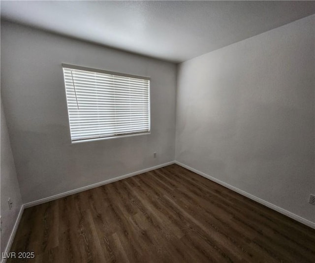 spare room featuring dark hardwood / wood-style flooring