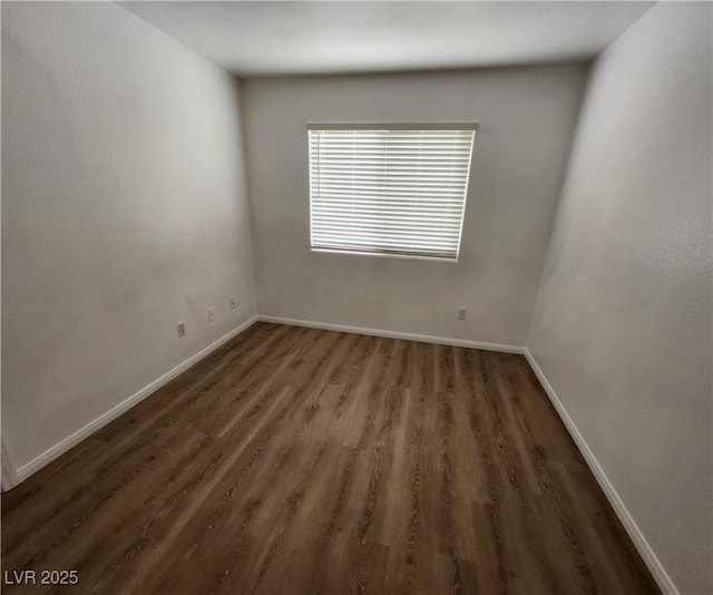 unfurnished room with dark wood-type flooring