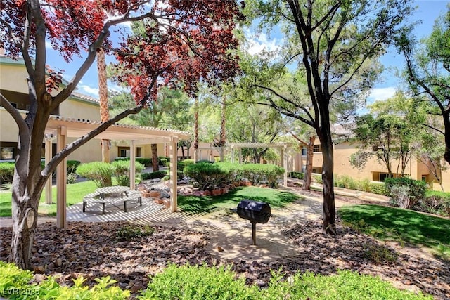 view of community with a pergola, a yard, and a patio area