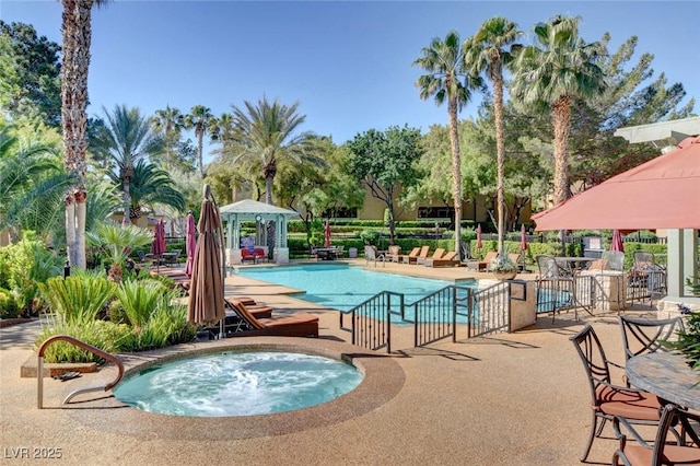 view of swimming pool with a gazebo, a patio area, and a community hot tub