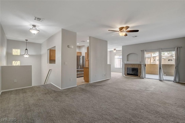 unfurnished living room with carpet flooring and ceiling fan