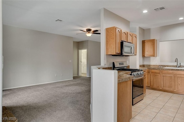 kitchen featuring sink, light tile patterned floors, ceiling fan, stainless steel appliances, and light brown cabinetry