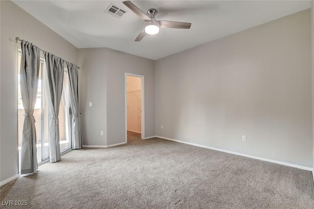 spare room featuring light carpet and ceiling fan