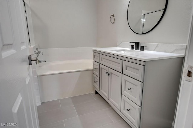 bathroom featuring tile patterned floors, vanity, and a tub