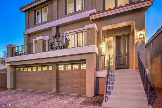 view of front of property featuring a garage and stucco siding