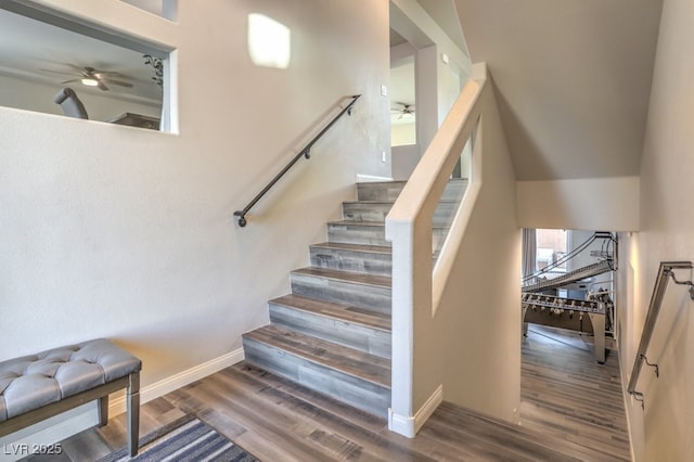 stairway featuring a ceiling fan, wood finished floors, and baseboards