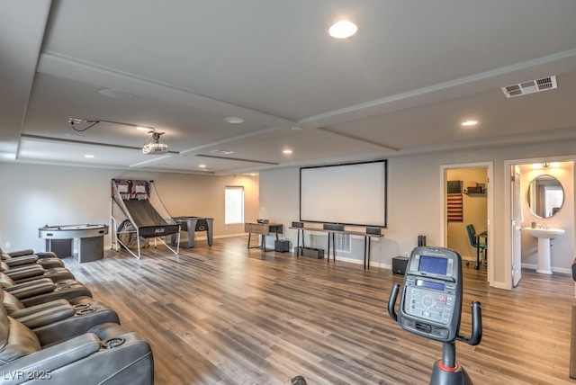 home theater room with recessed lighting, wood finished floors, visible vents, and baseboards