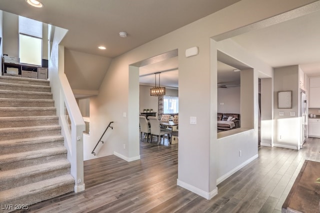 interior space with baseboards, stairway, recessed lighting, wood finished floors, and a notable chandelier