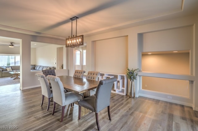 dining area with plenty of natural light, wood finished floors, and baseboards