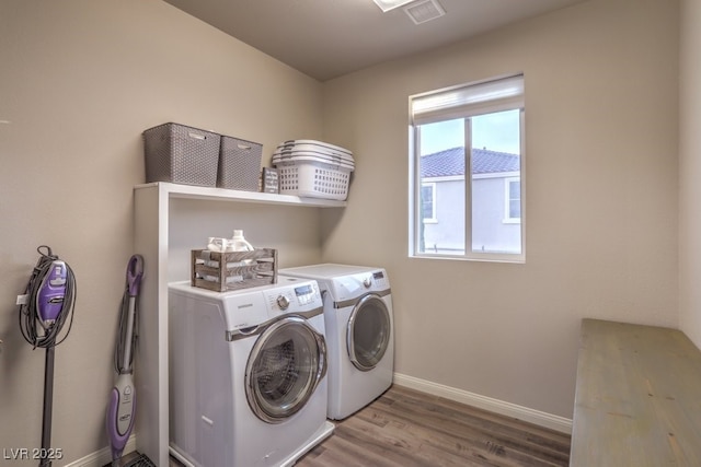 laundry room with washer and dryer, light wood-type flooring, baseboards, and laundry area