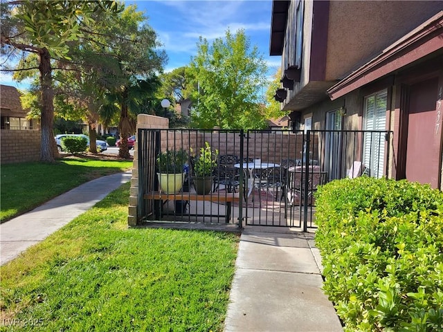 view of gate with a yard