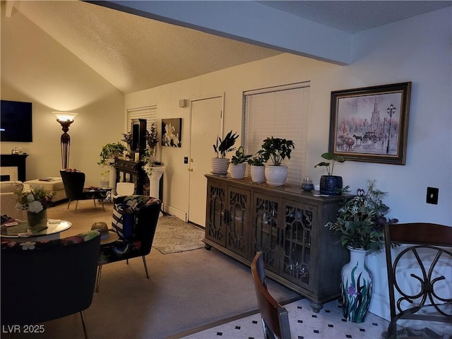 carpeted home office featuring vaulted ceiling and a textured ceiling