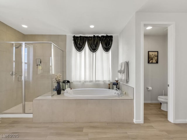 bathroom with toilet and separate shower and tub