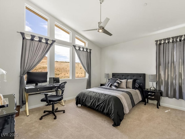 bedroom featuring vaulted ceiling, light colored carpet, and ceiling fan