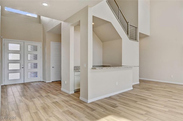 foyer with french doors and light hardwood / wood-style flooring