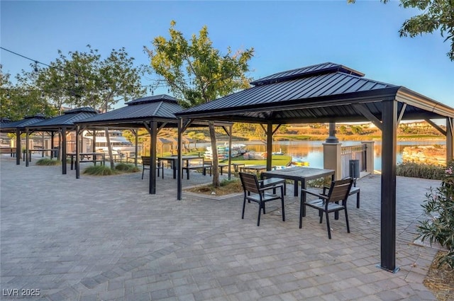 view of property's community with a gazebo and a water view